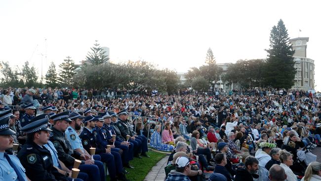 Members of the public and police officers seen at the vigil on Sunday night. Picture: Getty Images