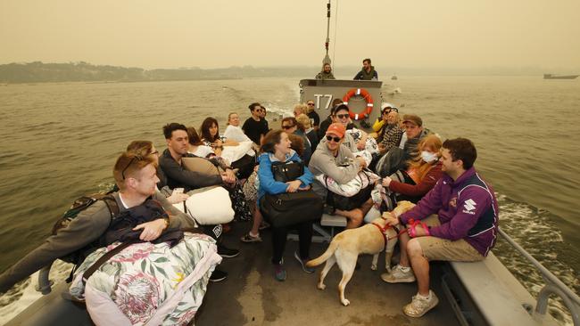 Evacuees are being ferried to the HMAS Choules in smaller boats. Picture: David Caird