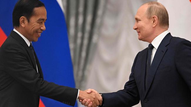 ‘Friends with everyone’: Joko Widodo shakes hands with Vladimir Putin at the Kremlin in Moscow on June. Picture: AFP