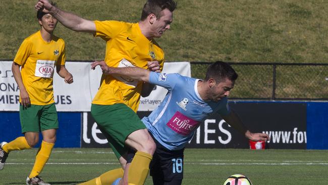 a Mt Druitt Town Rangers tries to tackle a Marconi Stallions player as he goes for the ball in the National Premier Leagues 2 NSW men's grand final in Edensor Park. Picture: Annika Enderborg