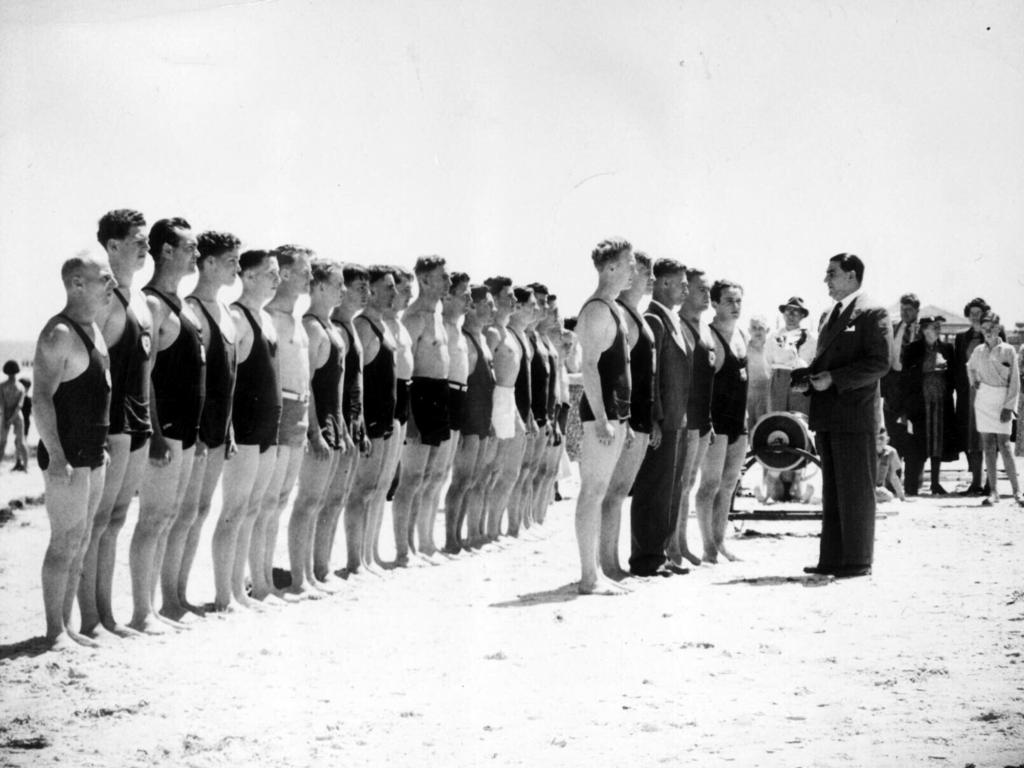 Glenelg mayor Jim Handby presenting Glenelg Lifesaving Club members cup for rescue efforts during 1948 hurricane storm.