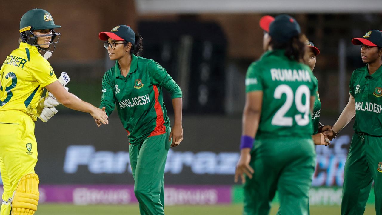 Australia's Ashleigh Gardner (L) is congratulated by Bangladesh players after Australia won during the Group A T20 women's World Cup cricket match between Australia and Bangladesh at St George's Park in Gqeberha on February 14, 2023. (Photo by Marco Longari / AFP)