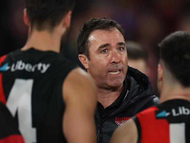 MELBOURNE, AUSTRALIA - AUGUST 16: Brad Scott, Senior Coach of the Bombers speaks to the team during the round 23 AFL match between Essendon Bombers and Sydney Swans at Marvel Stadium, on August 16, 2024, in Melbourne, Australia. (Photo by Daniel Pockett/Getty Images)