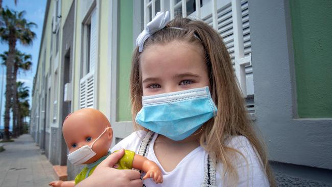 Naidelin, 5, and her doll pose wearing face masks in the street in Santa Cruz on the Canary Island of Tenerife. Picture: Desiree Martin/AFP