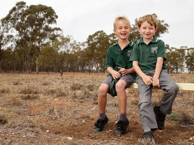 Students Levi McMahon, 6, and Jimmy Aveyard, 6, on the dry Tullamore Central School grounds. Picture: Jonathan Ng