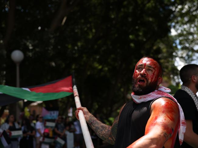 A man covered himself in fake blood during a pro-Palestine protest in Sydney’s Hyde Park, at the same time as another rally in Melbourne and one in support of Israel at Martin Place. Picture: NCA NewsWire/ Dylan Robinson