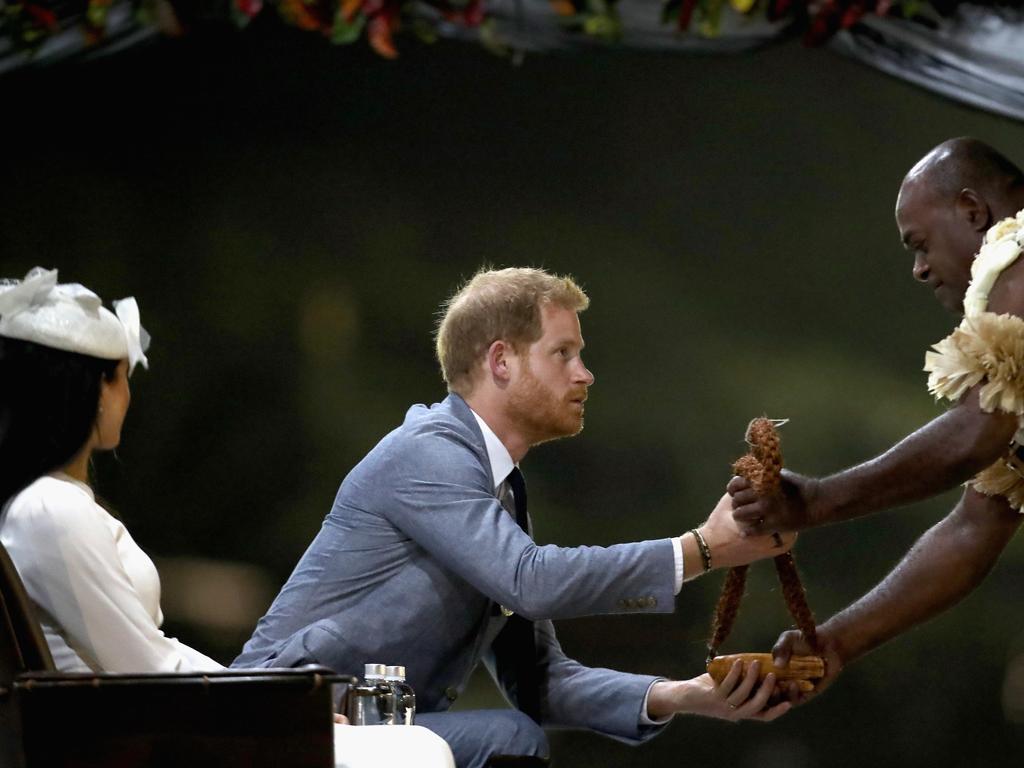 Prince Harry is presented with a gift and the Kava at the  welcome ceremony. Picture: Chris Jackson