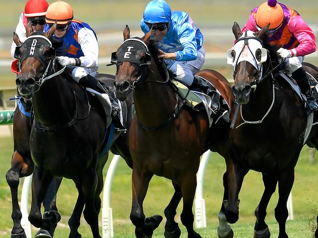 Jockey Ryan Maloney rides Scout (centre) to victory in race 2, the QTIS 3YO Handicap, during Metro Races at Doomben Racecourse in Brisbane, Saturday, December 7, 2019. (AAP Image/Albert Perez) NO ARCHIVING, EDITORIAL USE ONLY
