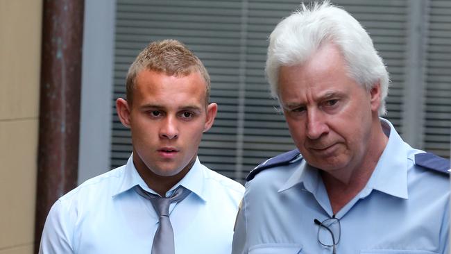 Kieran Loveridge being led away from court after being found guilty over the death of Thomas Kelly. Loveridge could soon leave prison on parole.