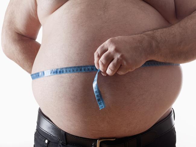 big belly of a fat man and measuring tape isolated on white