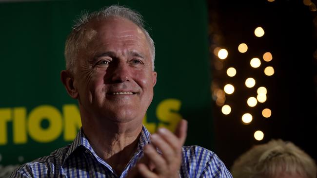 Prime minister Malcolm Turnbull listens as Barnaby Joyce claims his victory in the New England by-election at The Nationals Party at West Tamworth Leagues Club in Tamworth on Saturday, December 2, 2017. Former Deputy PM Barnaby Joyce is regained his former seat of New England. (AAP Image/Tracey Nearmy) NO ARCHIVING