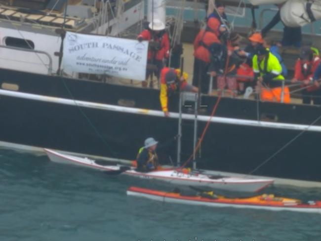 A screen grab from a video showing the dramatic rescue by crew aboard the tall training ship, South Passage, of two kayakers off Hinchinbrook Island in North Queensland on Thursday. Picture: Supplied