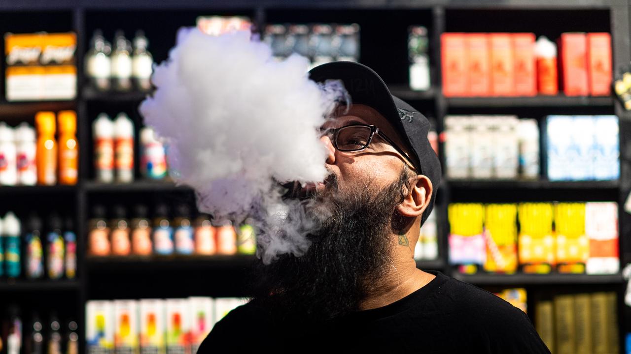 Vapourholics Darwin operations manager Jag Sekhon hits a vape. Picture: Che Chorley