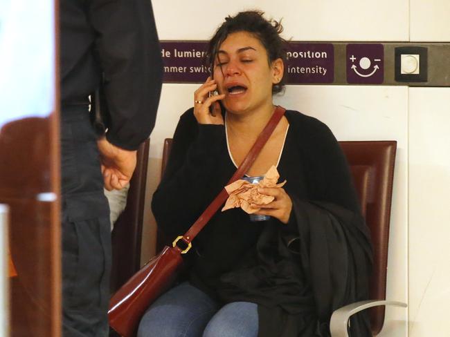 A relative of the victims of the EgyptAir flight 804 reacts as she makes a phone call at Charles de Gaulle Airport outside of Paris, Thursday, May 19, 2016. Egyptian aviation officials say an EgyptAir flight from Paris to Cairo with 66 passengers and crew on board has crashed. (AP Photo/Michel Euler)