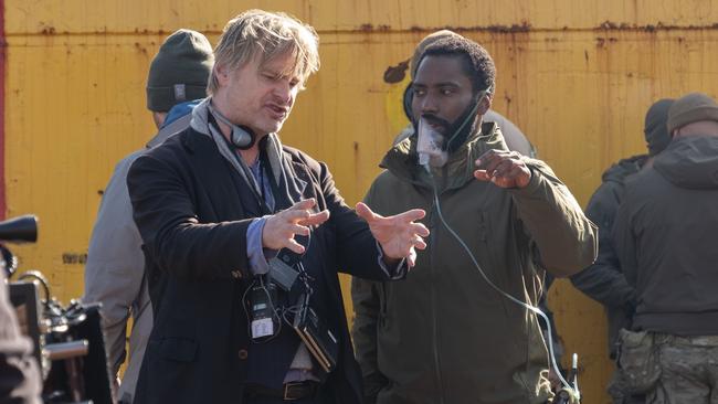 Washington and Christopher Nolan discussing a scene on set.