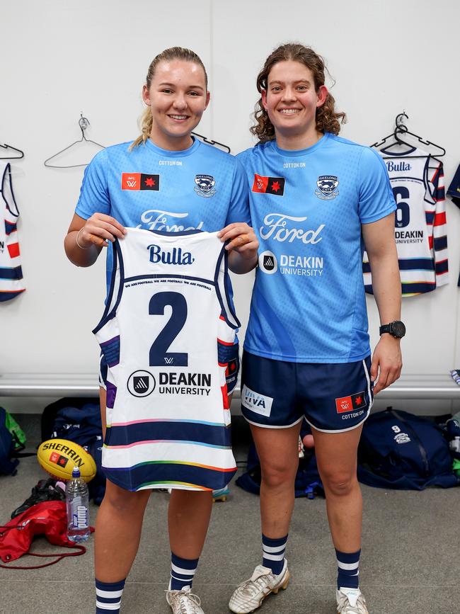 Geelong debutant Bella Smith is presented with her guernsey by teammate Nina Morrison. Picture: Brendon Thorne/AFL Photos/via Getty Images