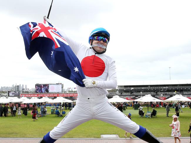 Shimizugawa Takashi from Tokyo wears a suit emblazoned with Japan’s flag while brandishing the Australian version. Picture: Michael Klein