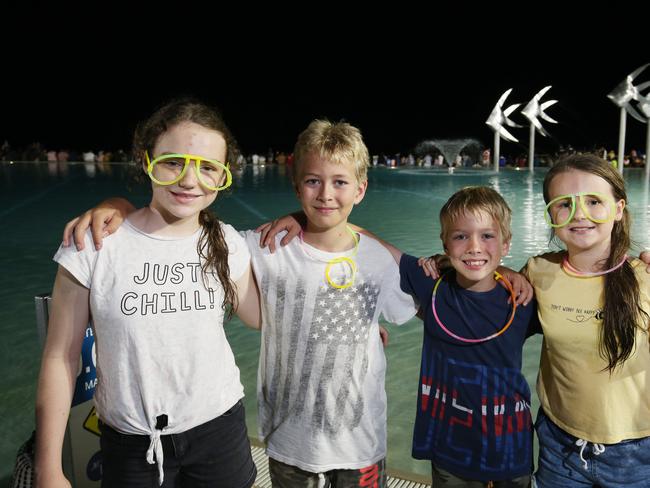 Ella Nel, 12, Noah Don, 10, Judah Don, 8, and Jade Nel, 10, get ready to watch the fireworks on New Year's Eve on the Cairns Esplanade. Picture: Brendan Radke