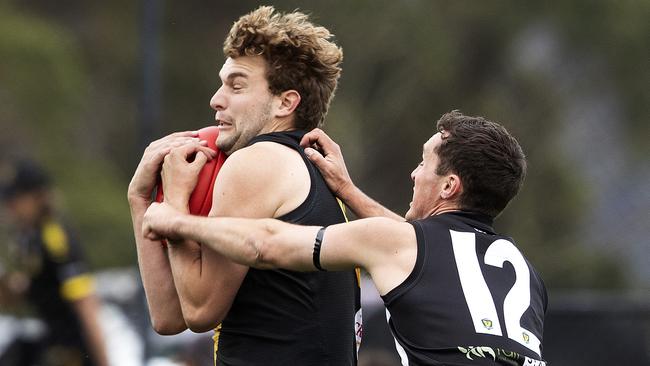 Tiger Tyler Carter marks in front of Glenorchy’s Daniel Joseph at Kingston. Picture: Chris Kidd