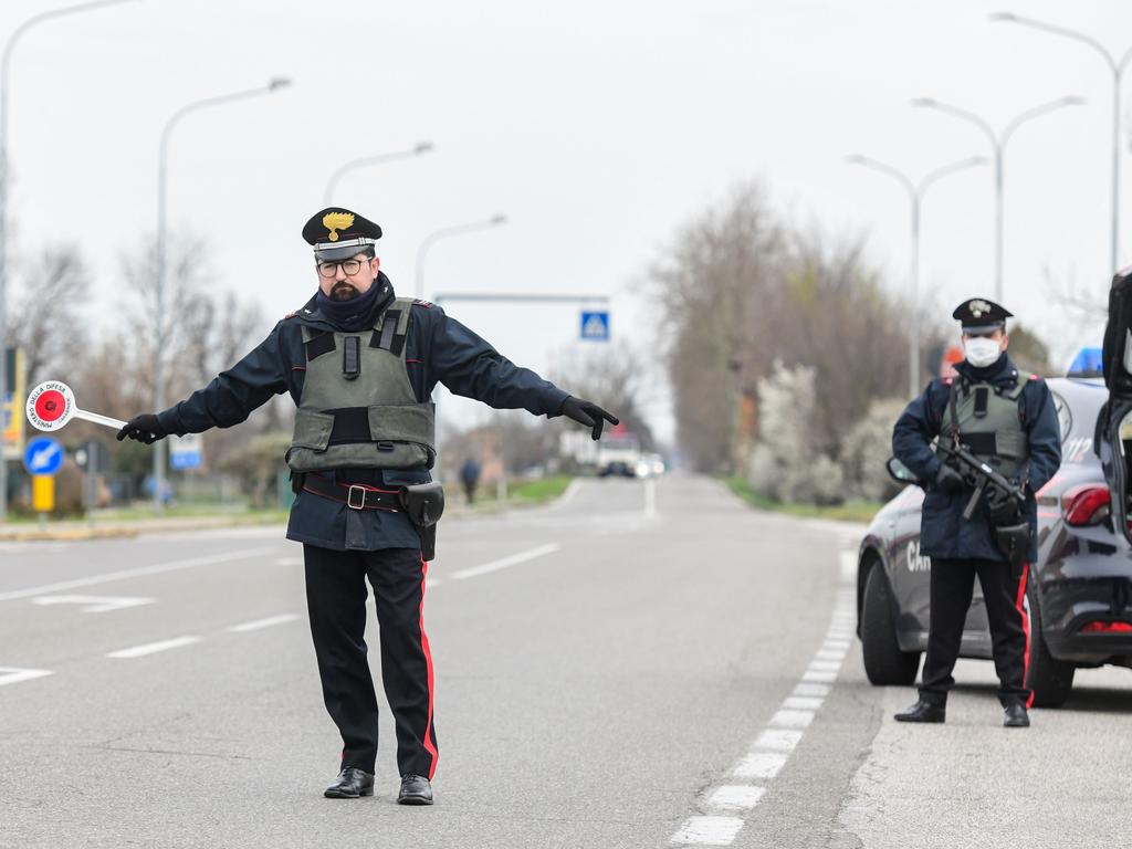 Armed Italian Carabinieri police officers hold a check point to enforce travel restrictions. Picture: Piero Cruciatti/AFP