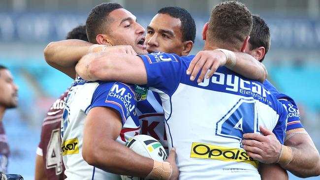 Marcelo Montoya celebrates a try with his Bulldogs teammates.