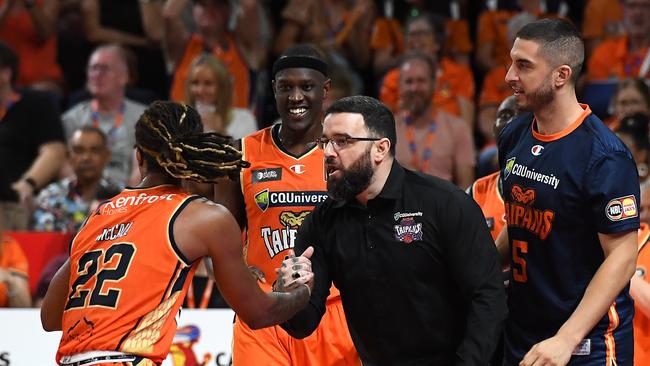 Cairns Taipans head coach Adam Forde helps up Tahjere McCall during the round three NBL match between the Cairns Taipans and Adelaide 36ers. (Photo by Albert Perez/Getty Images)