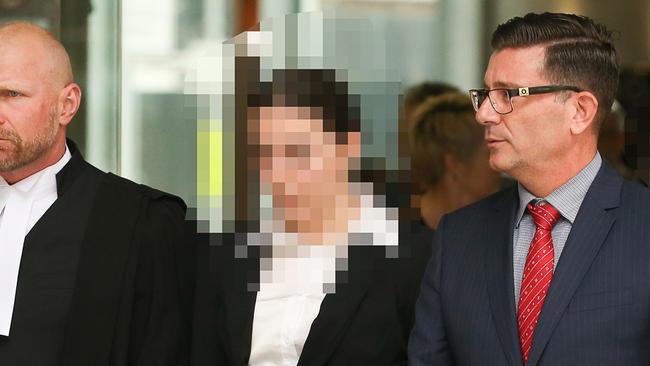 A woman (centre) who was under 18 at the time of the incident leaves Brisbane Supreme Court after sentencing in the matter of the torture and armed robbery of Cian English before his death.