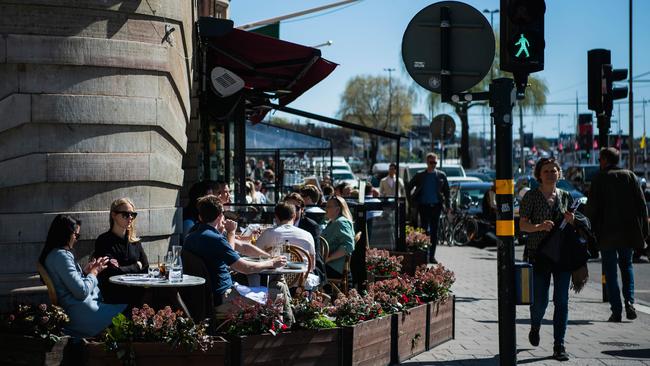 People have lunch at a restaurant in Stockholm in April, 2020, when much of the world was enduring lockdowns. Picture: AFP