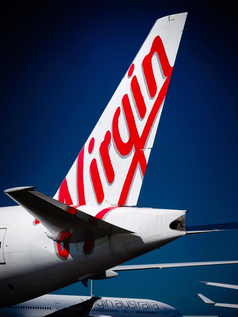 Virgin Australia aircraft are seen parked on the tarmac at Brisbane Airport. Picture: Patrick Hamilton/AFP