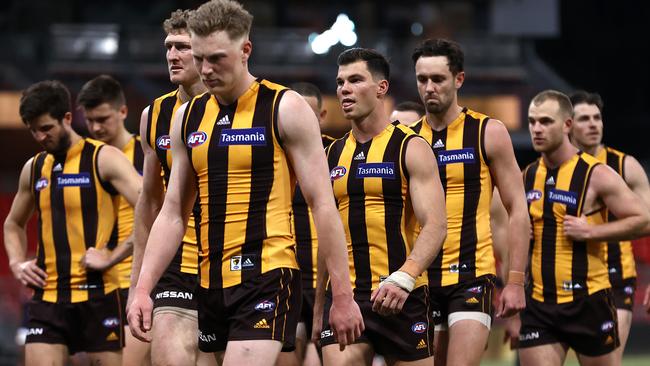 The dejected Hawks walk off Giants Stadium after losing to the Demons. Picture: Getty Images