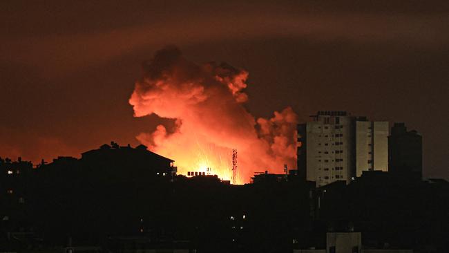 Fire and smoke rise above buildings in Gaza City during an Israeli air strike, on October 13, 2023, as raging battles between Israel and the Hamas movement continue for the sixth consecutive day. The United Nations was informed that Israel had ordered 1.1 million residents of northern Gaza to relocate to the south of the territory within 24 hours, a UN spokesperson told AFP on October 13, 2023, calling for the order to be rescinded on humanitarian grounds. (Photo by MAHMUD HAMS / AFP)