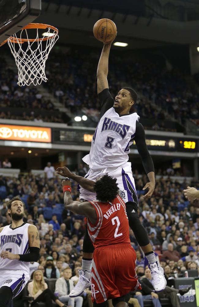 Sacramento Kings forward Rudy Gay goes up for a dunk over Houston Rockets guard Patrick Beverley.