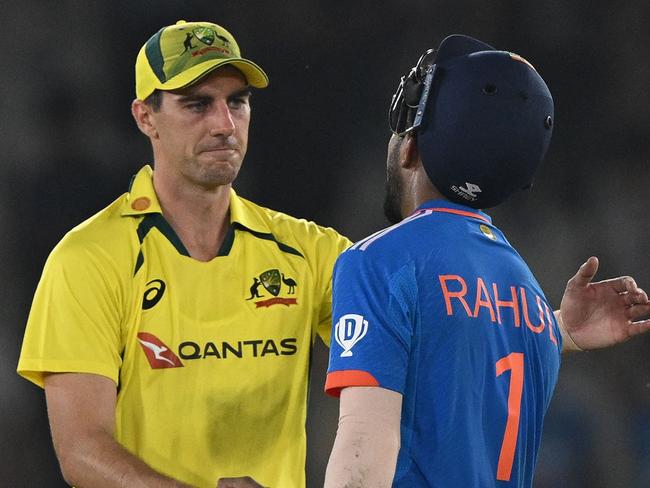 Australia's Pat Cummins congratulates India's KL Rahul (R) after India won the first one-day international (ODI) cricket match between India and Australia at the Punjab Cricket Association Stadium in Mohali on September 22, 2023. (Photo by ARUN SANKAR / AFP)