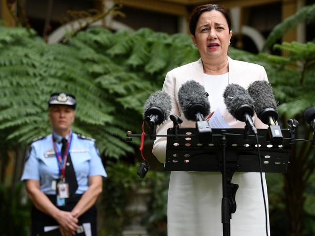 Queensland Premier Annastacia Palaszczuk, watched by Queensland Police Commissioner Katarina Carroll (left), speaks during a press conference at parliament House in Brisbane, Wednesday, April 8, 2020. The press conference addressed issues relating to the coronavirus COVID-19 pandemic. (AAP Image/Dan Peled) NO ARCHIVING