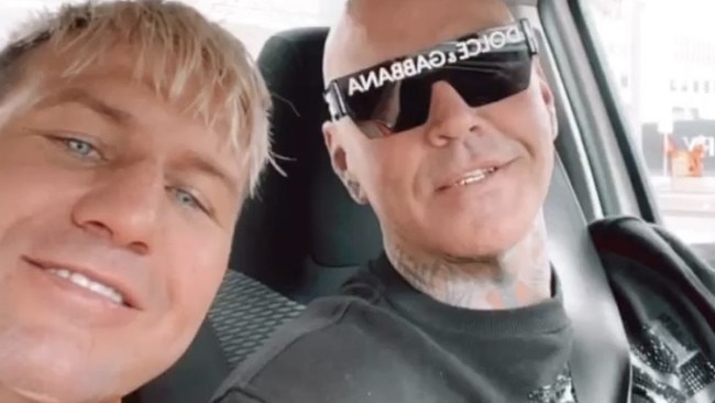 Fresh images show Mitchell celebrating his court victory in the back of a car with close associate and ex-Mongols bikie Dylan Goddard.