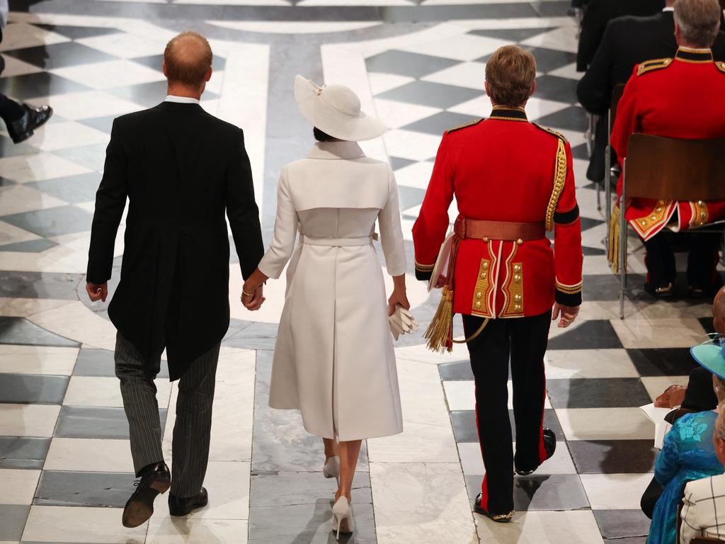 Prince Harry, Duke of Sussex, and Meghan, Duchess of Sussex are escorted to their seats. Picture: Getty Images