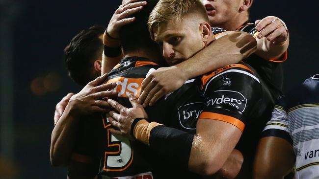 Joey Leilua of the Tigers celebrates scoring a try with team mates during the Round 6 NRL match between the Wests Tigers and the North Queensland Cowboys at Campbelltown Stadium in Sydney, Saturday, June 20, 2020. (AAP Image/Brendon Thorne) NO ARCHIVING, EDITORIAL USE ONLY