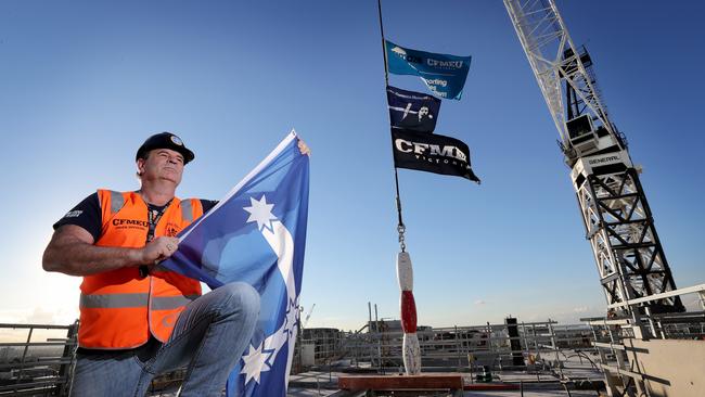 John Setka, then the Victorian secretary of the CFMEU, with Eureka and CFMEU flags on a crane in 2018. Picture: Stuart McEvoy