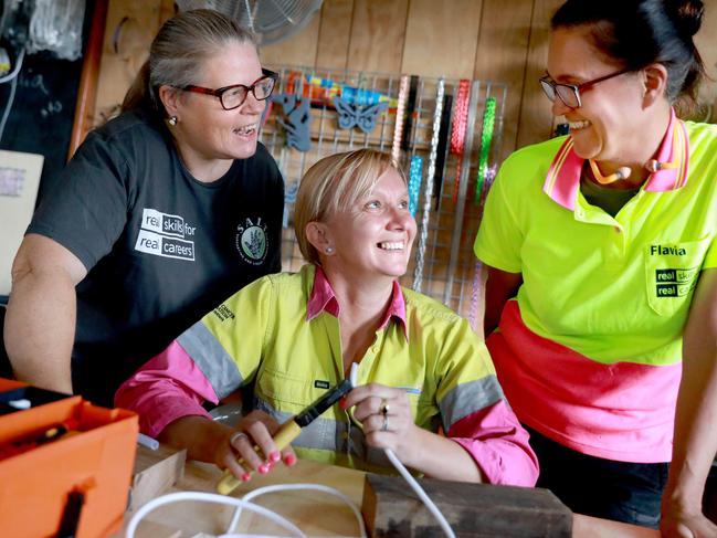 L-R painter and decorator Fiona Shewring, electrician Martina Fletcher, and carpenter Flavic Teixeira at SALT women's shed at Quakers Hill. (AAP IMAGE/ Angelo Velardo)