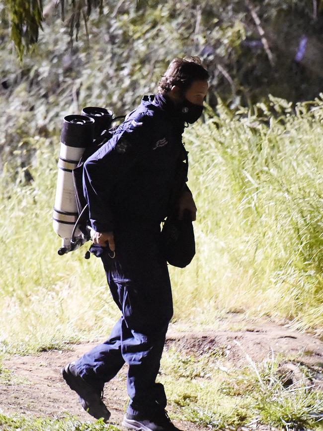 Police divers prepare to enter the water. Picture: Josie Hayden