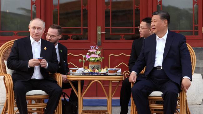 Russia's President Vladimir Putin and China's President Xi Jinping hold an informal meeting in Beijing on May 16. Picture: AFP