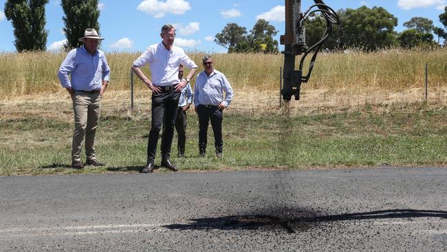 Regional Roads Minister Sam Farraway (left) and Premier Dominic Perrottet oversee some pothole repair work. Picture: Steve Gosch