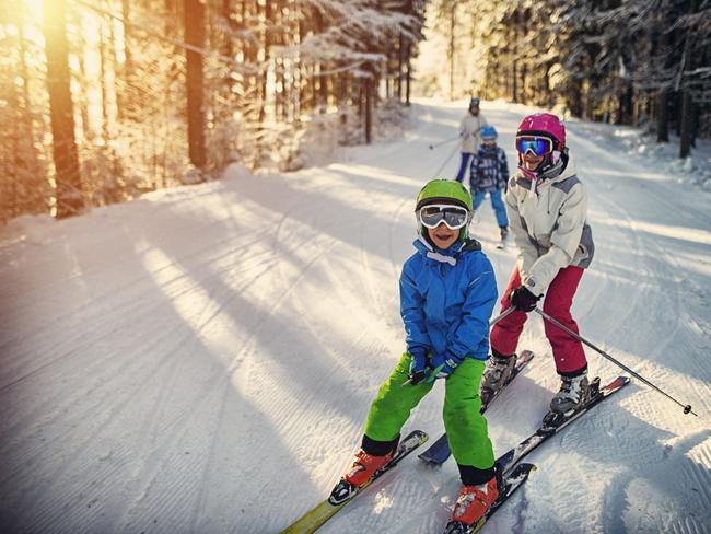 ESCAPE: How to save money on the slopes, by Lisa Mayoh, July 8. iStockMother with kids are skiing together down the ski slope. Everybody is laughing happily.