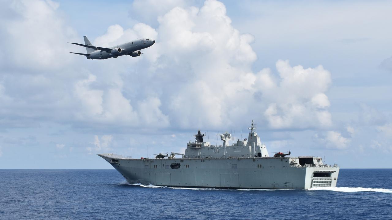 A RAAF P-8A Poseidon passes HMAS Adelaide as she sails in company with HMAS Darwin in the South East Asia, during Indo Pacific Endeavour 2017.