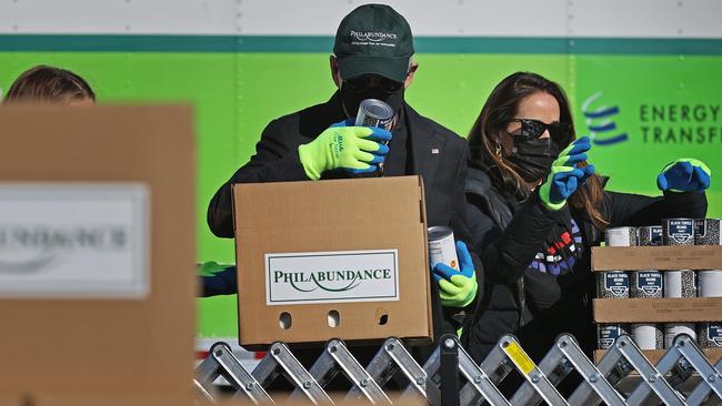 Joe Biden and daughter Ashley Biden volunteer to fill food donation boxes at the Philabundance food bank in Philadelphia on Tuesday. Picture: AFP