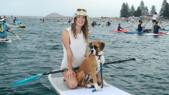 Jaimi Griffen, of Encounter Bay, and pet dog Tully were among a huge number of surfers and paddle-boarders who, in January, protested against plans to allow a tuna pen installed near Granite Island. Picture: Tom Huntley