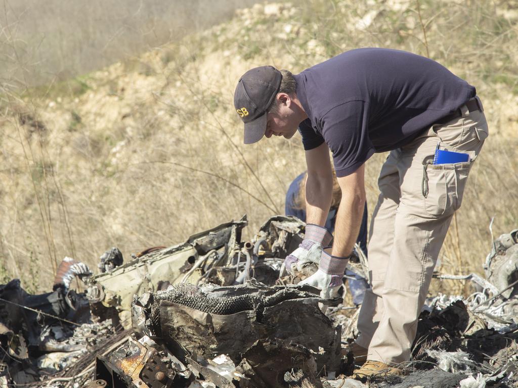 IAn investigator at the scene of the crash. Picture: AP