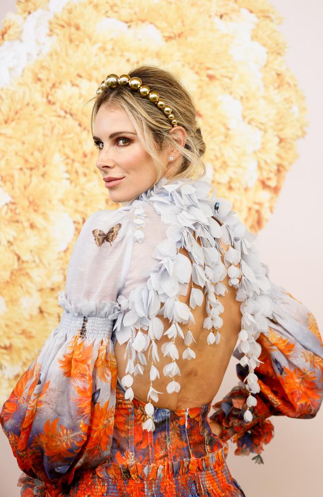 The SAS Australia star showing off the back of the $1,750 butterfly embellished minidress, by Zimmermann. Picture: Hanna Lassen/Getty Images