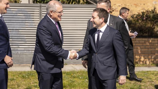 Prime Minister Scott Morrison, left, greets Victorian Leader of the Opposition Matthew Guy before speaking to the media at Leawarra railway station in Melbourne.