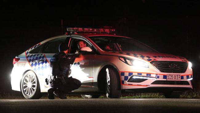 Police officers at Gatton last night as a siege continued. Picture: Marc Robertson